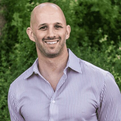 Man in button down shirt smiling