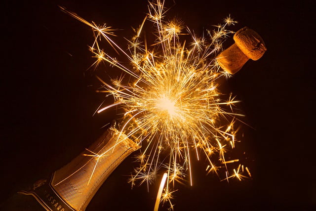 champgne bottle popping open with fireworks