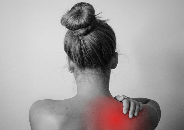 holding shoulder, red with pain