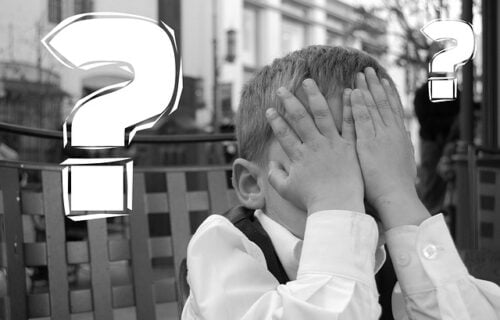 boy covering face with his hands